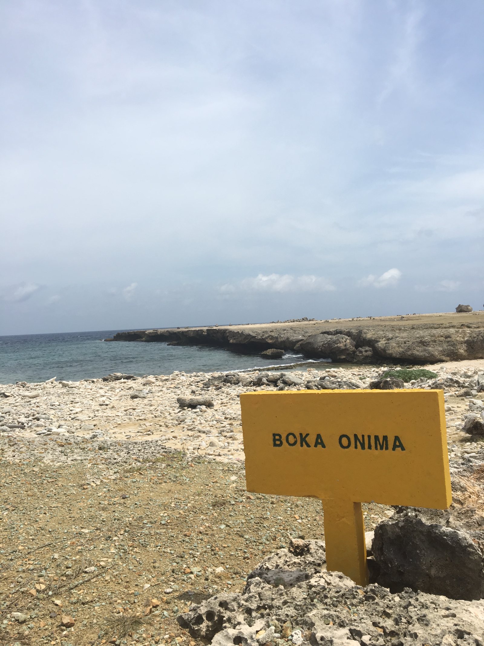 Yellow roadside sign reading BOKA ONIMA on the north-east coast of Bonaire